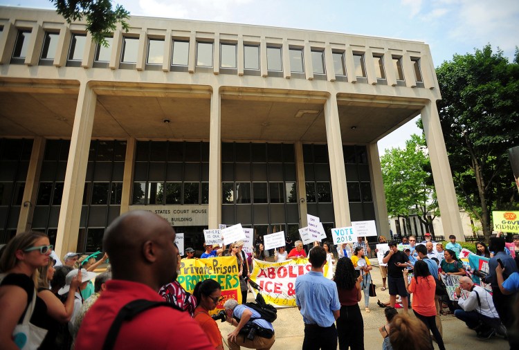 People hold a rally outside the Federal Courthouse in Bridgeport, Conn. on Wednesday, July 11, 2018. Lawyers for two immigrant children detained in Connecticut after being separated from their parents at the U.S.-Mexico border asked a federal judge on Wednesday to order that the girl and boy be reunited with their families. 