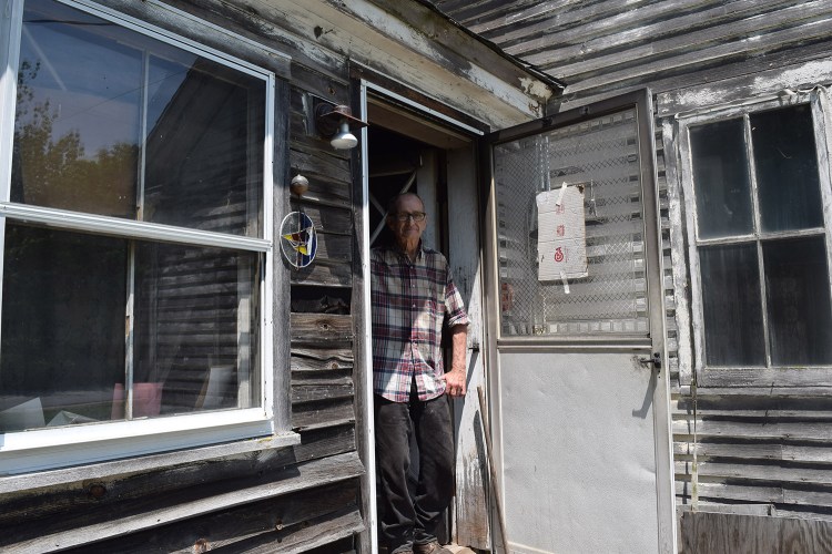 James Ross stands in the doorway of his home on River Road in Lisbon. A fox that was believed to be rabid entered an open door and attacked Ross in his kitchen. Ross, 82, halted the attack by using a meat cleaver.