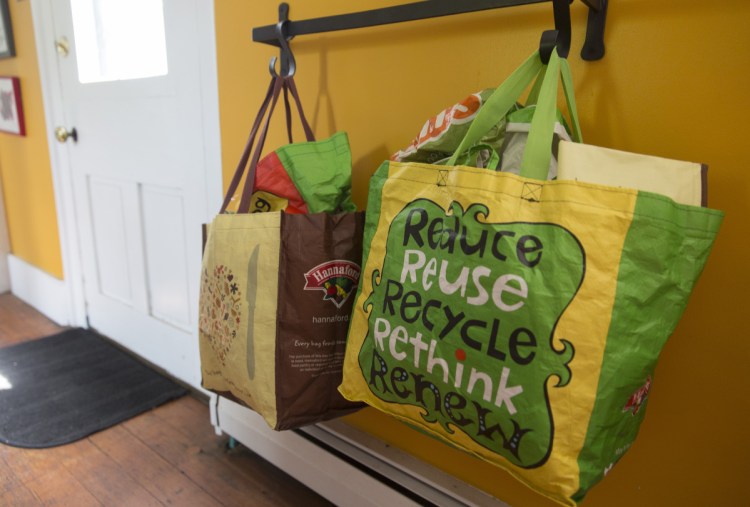 Reusable shopping bags hang by the door at Christine Burns Rudalevige's home.