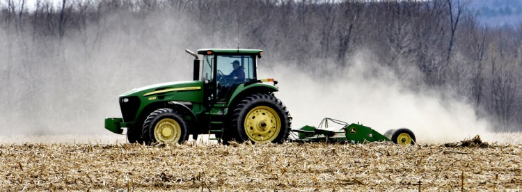 Dairy farmer Bussie York chops corn stalks at the Sandy River farm he owns in Farmington. He wants to lease 700 acres to a company that plans to install more than 300,000 solar panels. Developer NextEra says it would be the largest solar project in New England.