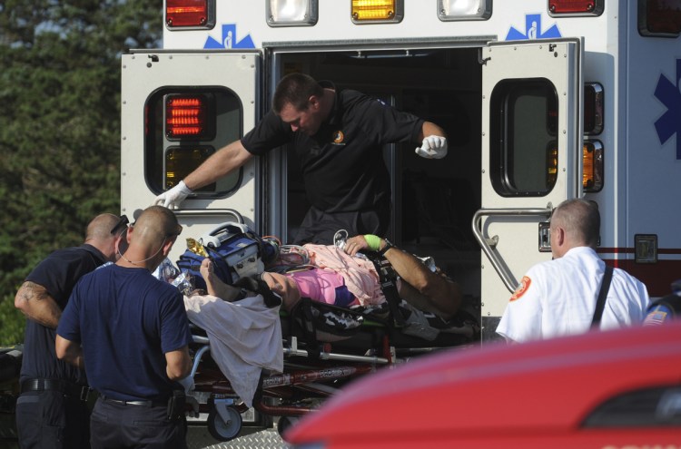 A man is transferred from a Truro ambulance to a MedFlight helicopter after being attacked by a shark, Wednesday, Aug. 15, 2018 in South Wellfleet, Mass. A man swimming off Cape Cod was attacked by a shark on Wednesday and was airlifted to a hospital. It was the first shark attack on a human on the popular summer tourist destination since 2012. (Merrily Cassidy