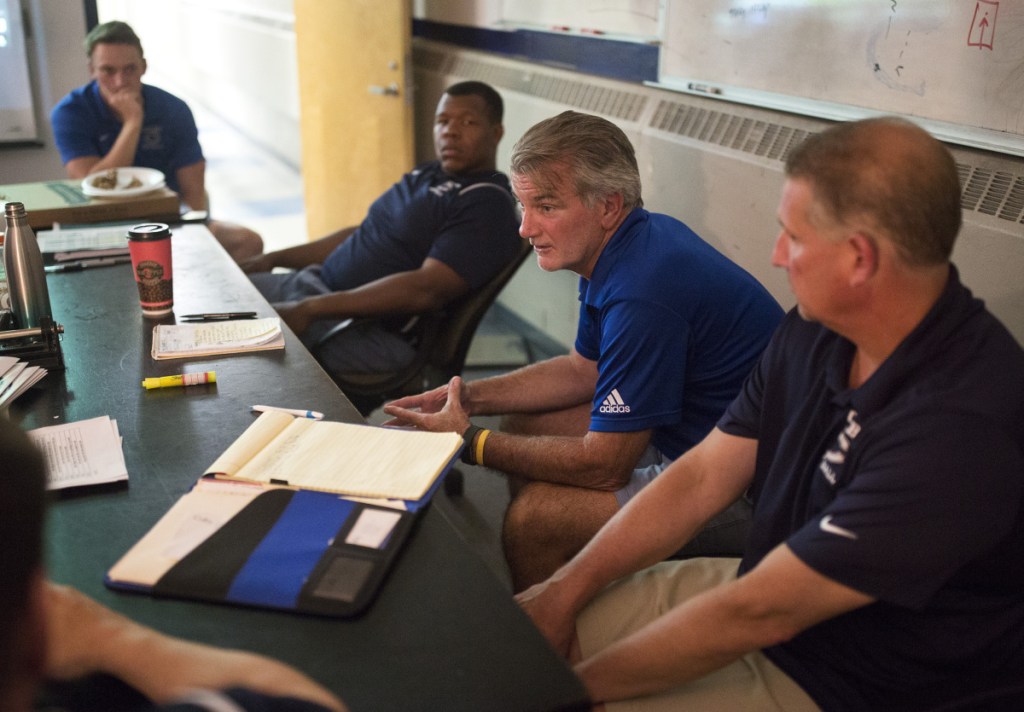 Jack Cosgrove, second from right, retained most of the coaching staff from last year's Colby team, including wide receivers coach Tom Dexter, right, and defensive coordinator Sean Conerly, second from left. Former Colby player Mark Snyder, left, is now the running backs coach after graduating in the spring.