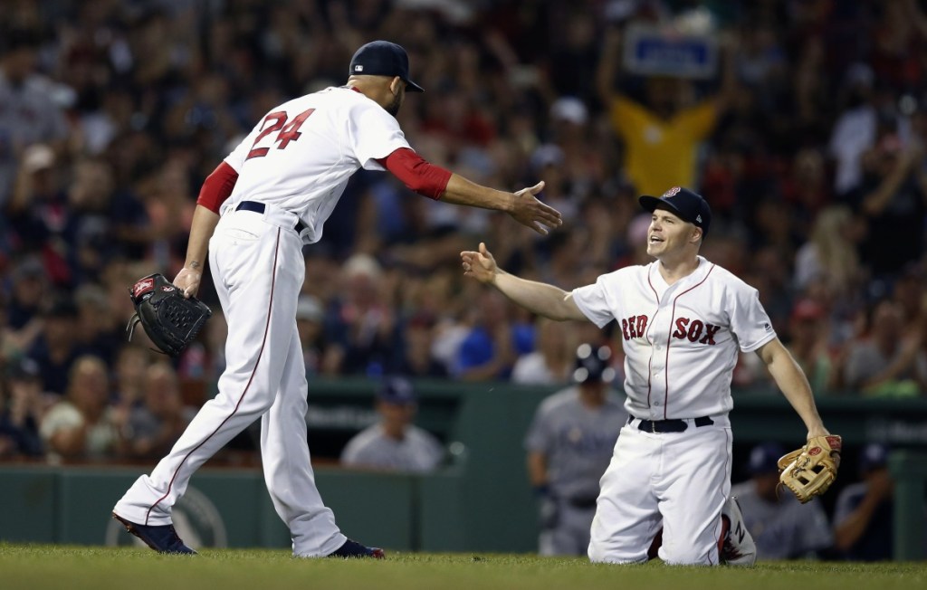 Red Sox pitcher David Price celebrates the out made by third baseman Brock Holt on a bunt attempt by Tampa Bay's Carlos Gomez. Price remained unbeaten since the All-Star break as the Red Sox won, 5-2.