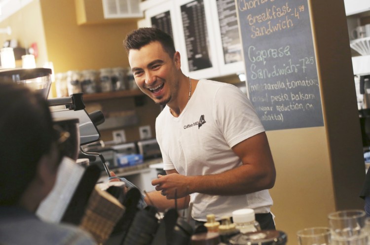 Mateo Hodo, owner of Coffee Me Up in Portland, makes lattes Sunday. "Diversity is the key to the economy," says the immigrant from Albania.