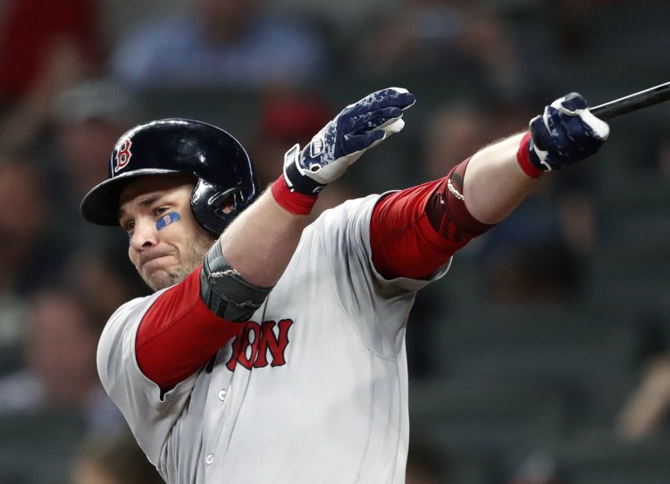 Boston's Steve Pearce follows through on a two-run hit in the sixth inning Tuesday night in Atlanta. Pearce had three hits and three RBI in Boston's 5-1 win.