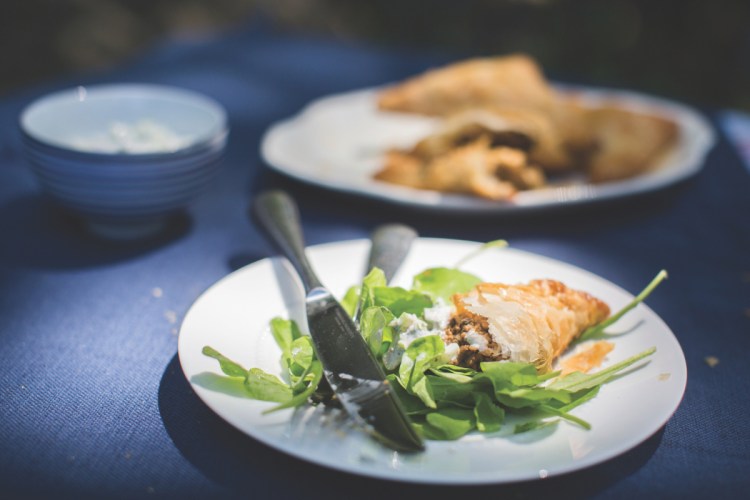 Lamb turnovers with herby yogurt sauce.