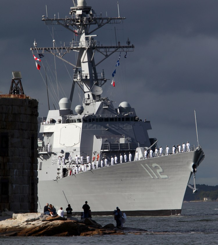 Sailors stand at the rail of the USS Michael Murphy, the last of the U.S. Navy's original run of 62 Arleigh Burke-class destroyers, as the BIW-built ship heads down the Kennebec River off Phippsburg in 2012.