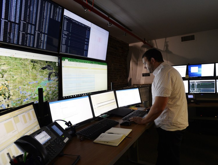 Jake Theriault remotely observes solar and wind projects across the country from Longroad Energy Partners' $1 million facility in downtown Portland on Sept. 6.