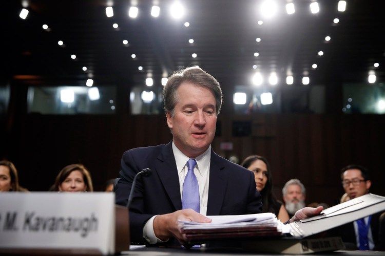 Supreme Court nominee Brett Kavanaugh readies his papers before he testifies before the Senate Judiciary Committee on Thursday, the third day of his confirmation hearing.