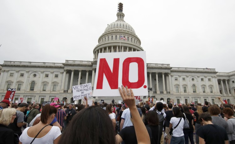 Activists demonstrate in the plaza of the East Front of the U.S. Capitol to protest the confirmation vote of Supreme Court nominee Brett Kavanaugh on Capitol Hill on Saturday in Washington.