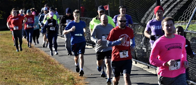 Racers take off at the start of the Terrier Trot event that was part of the Thomas College Homecoming weekend on Sunday. Runners ran on the new Sukeforth Family Trust System that is open to the public.