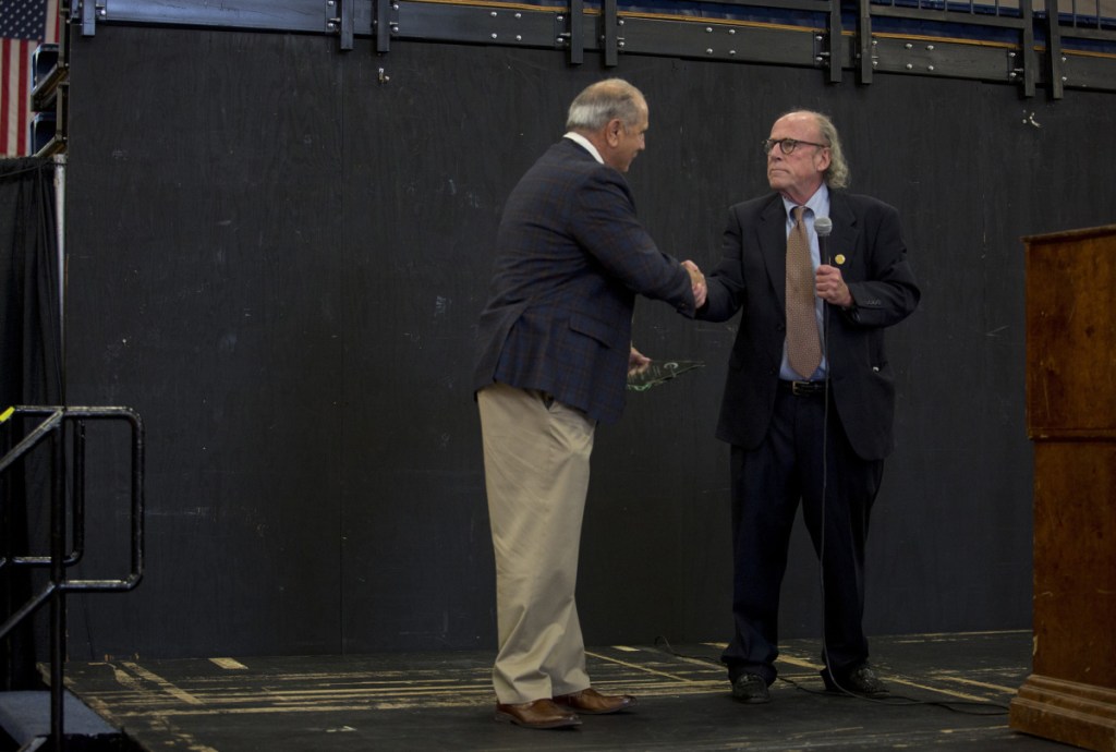 PORTLAND, ME - OCTOBER 11: York County Sheriff William King, left, shakes hands with Timothy Cheney, of ENSO Recovery, while receiving an award at the Recovery Job Fair at the Portland Expo on Thursday, October 11, 2018. Sheriff King's office is working with ENSO Recovery, a local addiction recovery group, to bring medication-assisted treatment to prisoners at the jail. (Staff photo by Brianna Soukup/Staff Photographer)