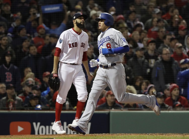 Manny Machado of the Dodgers runs past Boston pitcher David Price to score on an RBI-single by Yasiel Puig during the fourth inning of Game 2 of the World Series on Wednesday.