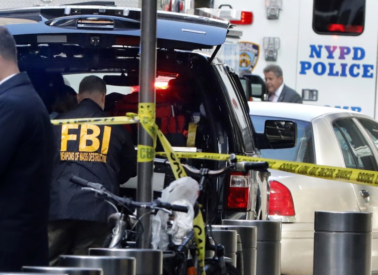 A member of the FBI Weapons of Mass Destruction team works outside the Time Warner Center on Wednesday in New York City, where CNN's offices and newsroom were evacuated because of a suspicious package.