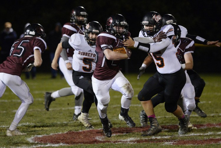 Staff photo by Shawn Patrick Ouellette
Greely's Joey Cassella tries to break free from Biddeford's Alex McAlevey during the Rangers' 22-14 win in the Class B South quarterfinals on Friday in Cumberland.