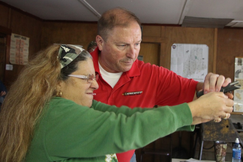 Franklin County Sheriff Scott Nichols Sr. leads Josette Billian of Wilton through a series of drills during a basic handgun training course in Wilton.