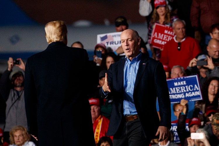 Rep. Greg Gianforte, R-Mont., is greeted on stage by President Donald Trump during a campaign rally in Missoula on Thursday.