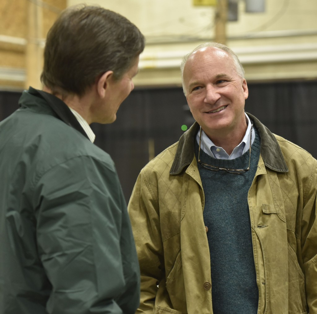 Derek Langhauser, right, president of the Maine Community College System, speaks with Robert Kump, of Avangrid Networks, during an open house Wednesday at Kennebec Valley Community College in Fairfield.