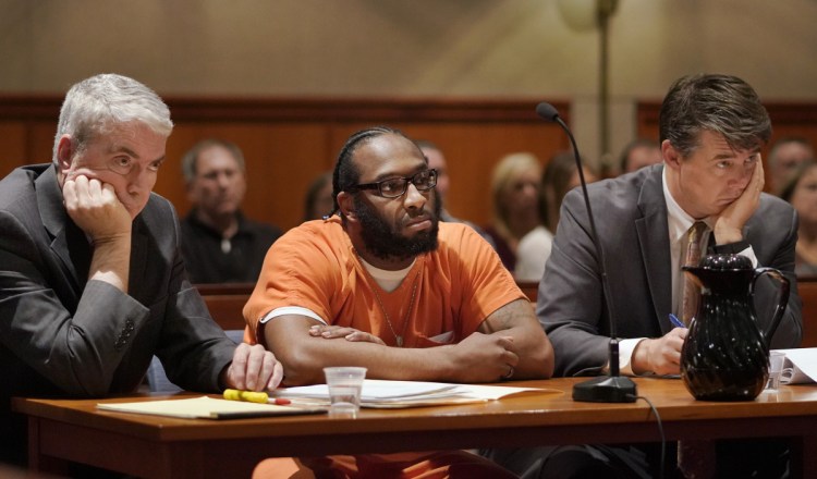 David Marble, with his attorneys Neale Duffet, left, and Jon Gale, listens as Justice Michaela Murphy reads his sentence at the Cumberland County Courthouse in Portland on Friday. Marble, who was found guilty of murdering Eric Williams and Bonnie Royer, was sentenced to life in prison without the possibility of parole.