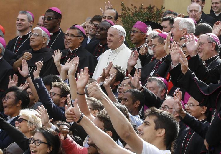 Pope Francis poses for a group photo with Catholic bishops and other participants during the last day of the synod of bishops at the Vatican last Saturday.