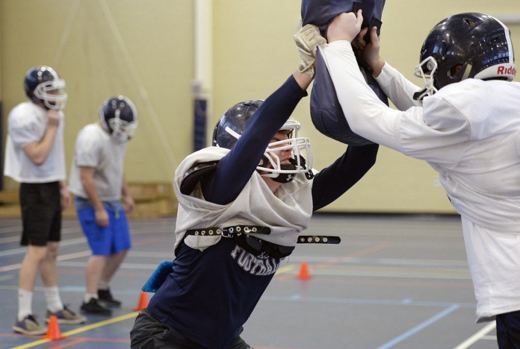 Linebacker Jack Campbell, center, runs a drill during practice Wednesday as Fryeburg Academy prepares for the Class C state championship game Saturday against Nokomis.