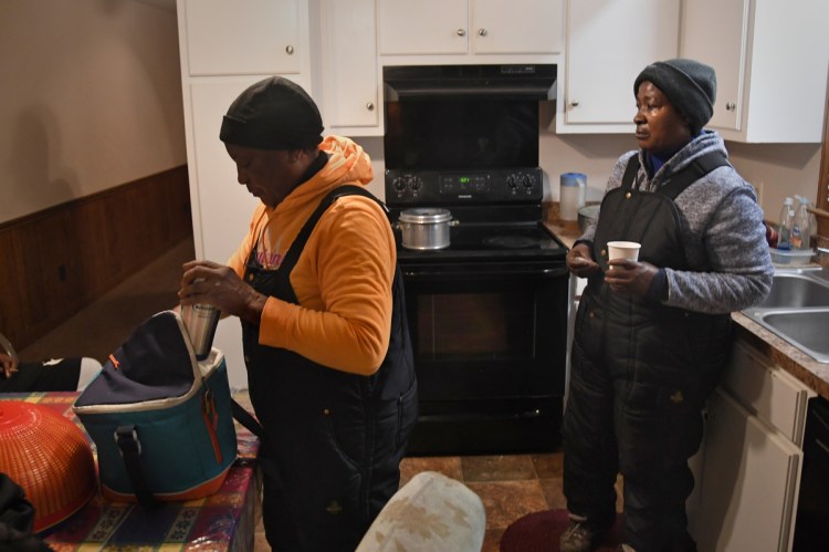 Elisena Joseph, left, and roommate Nelta Gilles get ready for work at the Mount Olive, N.C., Butterball turkey processing plant. Joseph, 63, began working at the factory in 2012, two years after the massive earthquake in Haiti forced her to leave her home behind. She sends much of her paycheck back to her village in Haiti to help her five children and grandchildren.