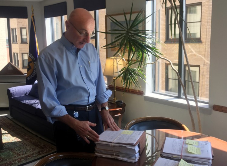 Mark Robbins, the last remaining member of the Merit Systems Protection Board, looks through stacks of legal cases piled up on his desk in Washington office. Robbins reads through federal workplace disputes, analyzes the cases, marks them with notes and logs his legal opinions. He then passes them along to nobody. He's the only member of a three-member board that legally can't operate until the president and Congress give him at least one colleague.