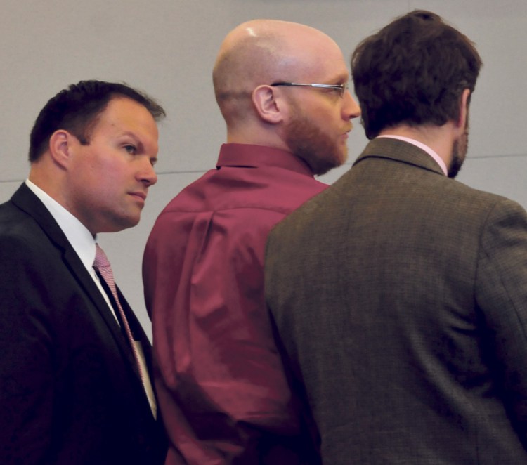 Murder case defendant Robert Burton, center, listens to guilty verdicts being read alongside his attorneys, Zachary Brandmeir, left, and Hunter Tzovarras, in October 2017 at Penobscot Judicial Center in Bangor.