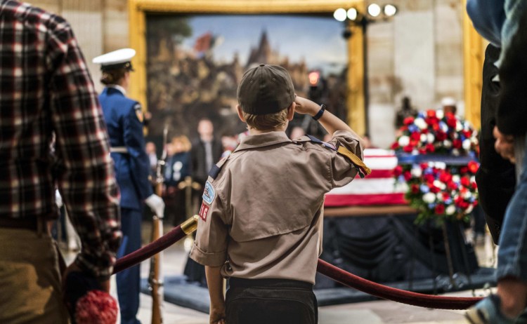 Crowds gather during the public viewing Monday as former President George H.W. Bush lies in state, on the same structure first used for Abraham Lincoln's casket after his assassination.