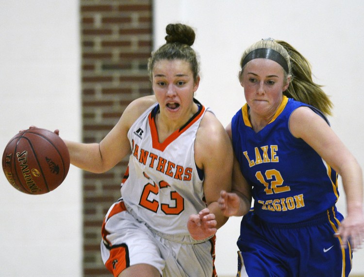 Serena Mower of North Yarmouth Academy, left, drives against Shauna Hancock of Lake Region during NYA's 51-17 victory at home Monday night.