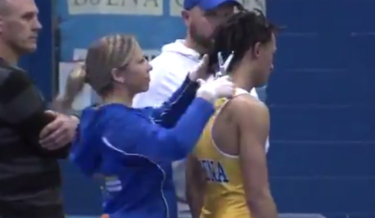 Andrew Johnson gets his hair cut Wednesday minutes before a match in Buena, N.J., after a referee told Johnson he would forfeit his bout if he kept his dreadlocks. Johnson won the match and the state's governing body recommended the referee not be assigned to any other event.