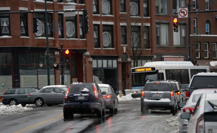 Traffic is stopped at the light at Congress and High streets in Portland. Better timing of traffic signals saves time, money and makes intersections safer.