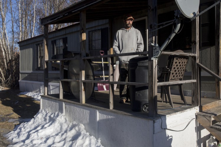 Michael Pradon, 39, stands Wednesday on the deck of his Waterboro home, where he found 35-year-old Derek Tarbox inside on Sunday. Tarbox told the homeowner it was a misunderstanding, but Pradon later found evidence of a break-in.