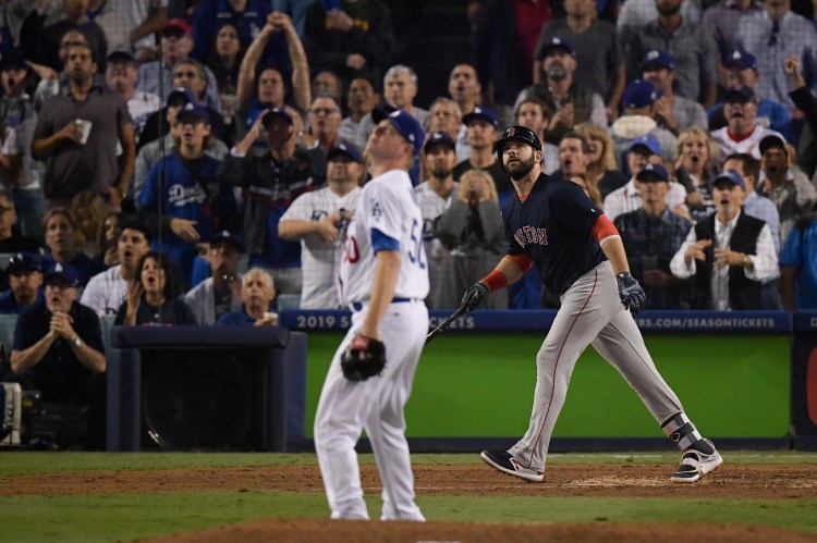 Boston Red Sox's Mitch Moreland watches his three-run home run off Los Angeles Dodgers relief pitcher Ryan Madson during the seventh inning in Game 4 of the World Series, which helped the Red Sox recover after losing Game 3 in the 18th inning. 