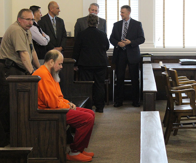 Rondon Athayde, 46, sits in Oxford County Superior Court on Friday morning as he waits for his initial court appearance in the death of his longtime girlfriend, Ana Cordeiro.