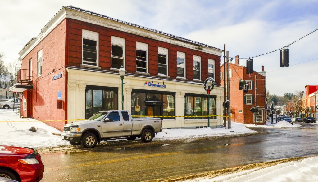 Plywood blocks the second-floor windows Thursday of this building on Water Street in downtown Gardiner. The building housed a Domino's pizza shop and several offices until fire damaged it severely on Dec. 28.