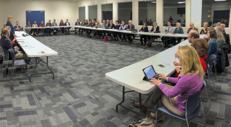 Gov. Janet Mills, standing at left, updates stakeholders about Medicaid expansion in Maine during a discussion Thursday in Hallowell. She said her budget would continue to fund the expansion and would do so without raising taxes in Maine.