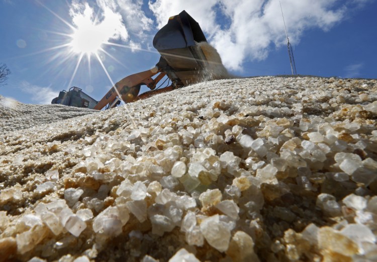 Road salt is mixed by a front-end loader before being divided among public works trucks in Freeport in 2018.