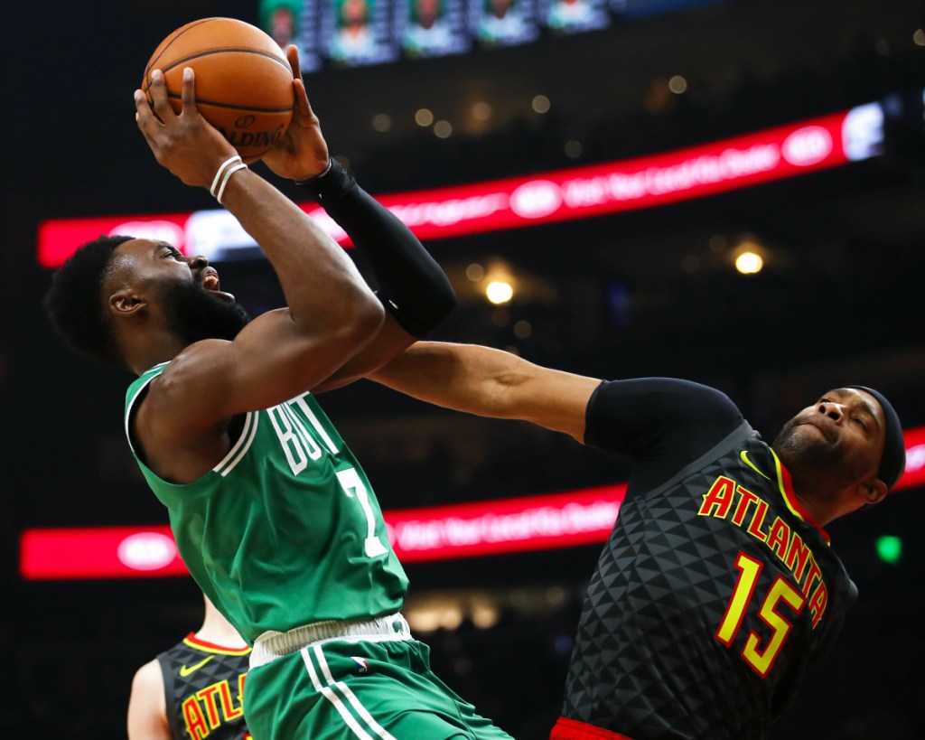 Jaylen Brown of the Celtics drives against Vince Carter of the Hawks during Saturday's game in Atlanta. The Celtics won, 113-105.