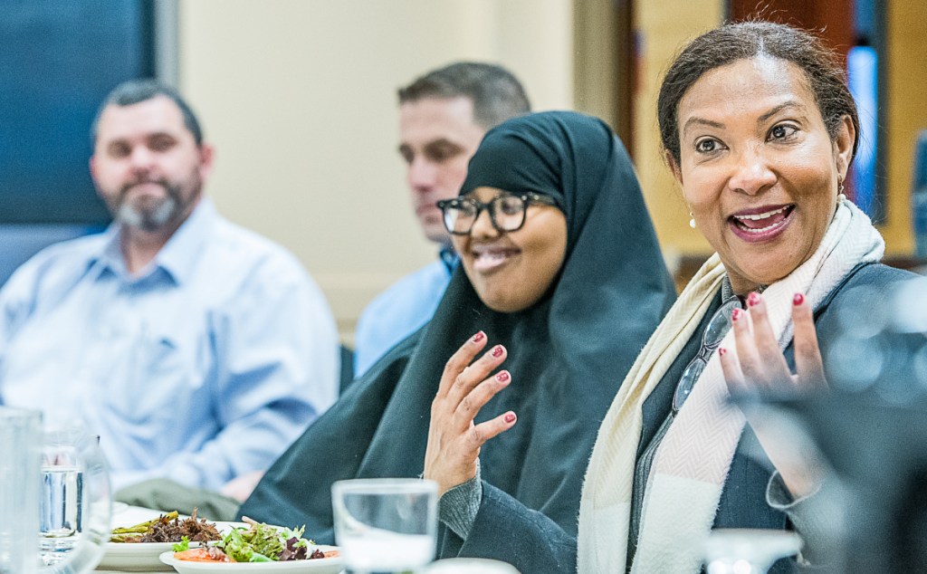 Christiana Otuwa, right, speaks to students Wednesday in Lewiston. Seated, from left, are: Lewiston High School Principal Jake Langlois, Lewiston Regional Technical Center Director Rob Callahan and student Koos Mohamed.