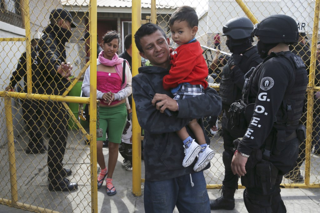 A Central American family that is part of a migrant caravan leaves a shelter Tuesday in Piedras Negras, Mexico, across the border from Eagle Pass, Texas.