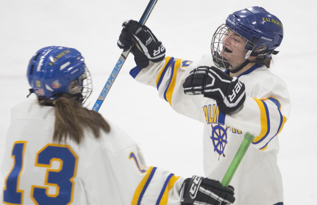 Kayla Sarazin, right, celebrates her fourth goal of the game along with Viviana Griffin as Falmouth puts the finishing touches on a 7-1 win over Portland/Deering in the first round of the girls' hockey playoffs Wednesday.