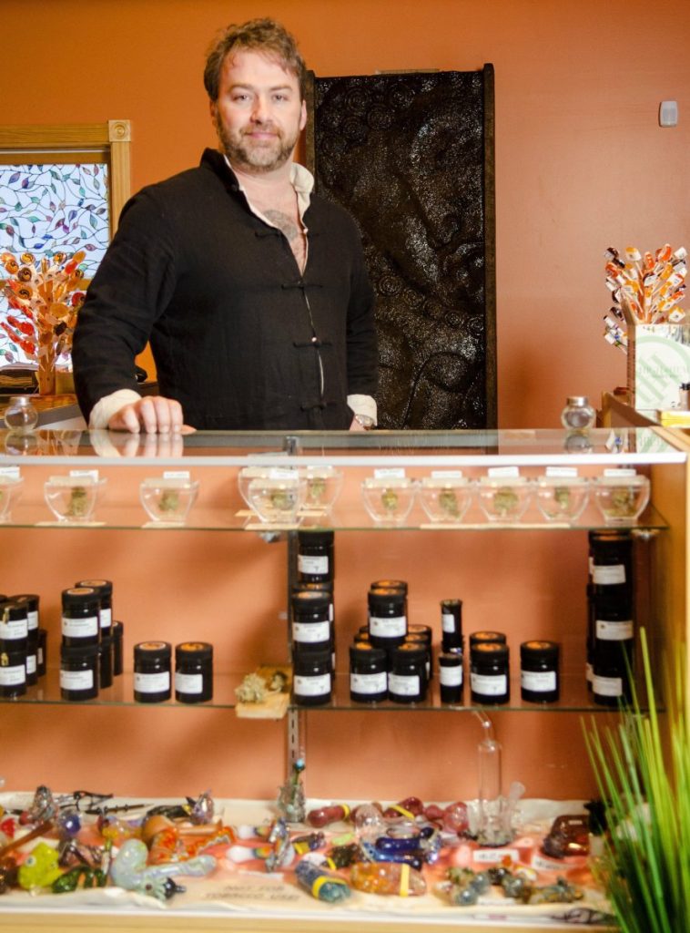 Owner Jake McClure stands behind the counter at the Sensi Sensei shop in Jefferson. McClure, who worked with a committee to draft an ordinance, said a selling point for Washington officials was supporting local farmers instead of big companies.