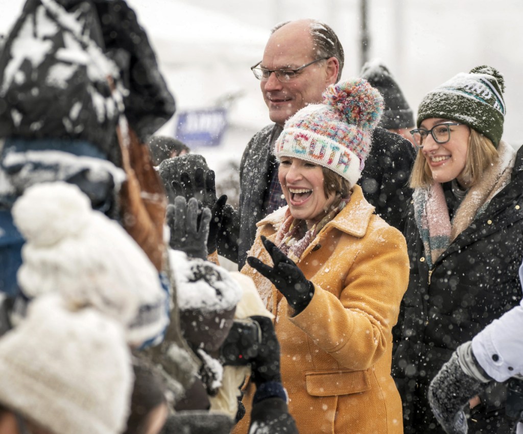 U.S. Sen. Amy Klobuchar greets supporters after her speech Sunday, as she is accompanied by her daughter Abigail and husband, John.