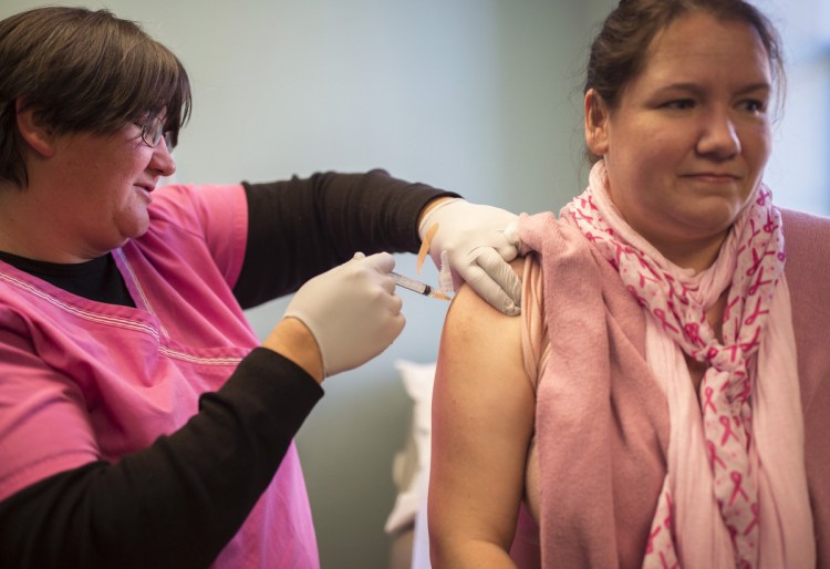 Medical assistant Cathy Fadden gives Leah Young a vaccine to prevent pertussis at Nasson Health Care in Sanford last fall. 