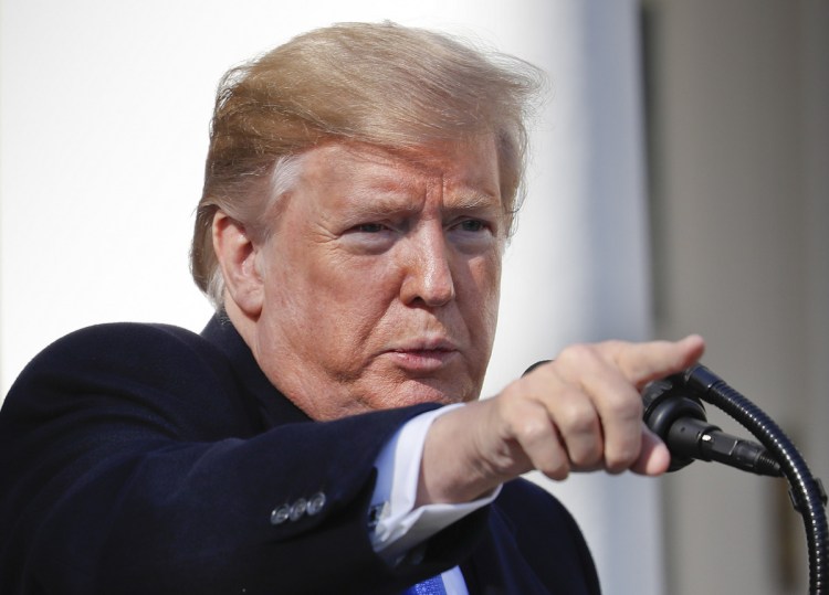 President Trump takes questions Friday after speaking during an event in the White House Rose Garden to declare a national emergency in order to build a wall along the U.S. southern border.