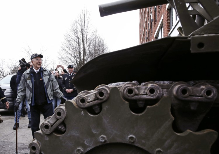 World War II tank gunner Clarence Smoyer admires a tank near the Charlestown Naval Shipyard in Boston, Wednesday. 