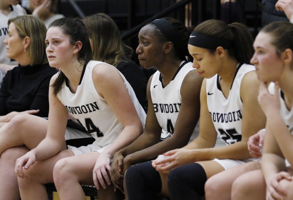 Bowdoin's Maddie Hasson, left, comforts teammate Taylor Choate following their loss to Tufts in the NESCAC women's basketball championship game Sunday in Brunswick. The Polar Bears went into the game as the No. 1 team in NCAA Division III and are still likely to be picked as a host school for the first two rounds of the NCAA tournament.