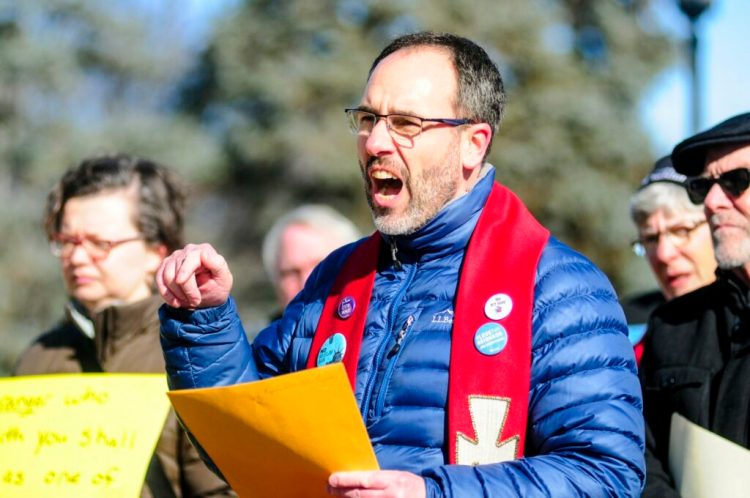 The Rev. Allen Ewing-Merrill speaks at Wednesday's rally in Augusta. Faith leaders from around the state gathered to bring attention to the detention of immigrant children in facilities across the nation.