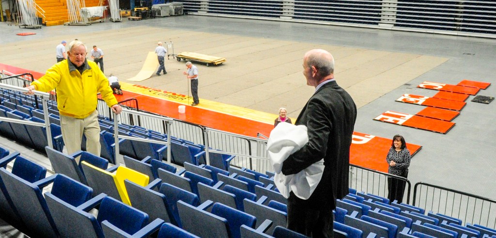 Basketball fan and former coach Ed Coffin, left, had a his favorite seat commemorated with an yellow paint job and a personalized plaque that was unveiled by center director Earl Kingsbury, right, on Thursday in the Augusta Civic Center